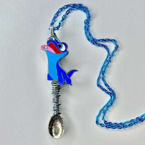 Custom Tiny Festival Spoon Pendant Necklace featuring a blue lizard catching a snowflake on it's tongue as a centerpiece charm with matching wire wrapping details on a large scoop size silver spoon base with a light blue necklace chain.